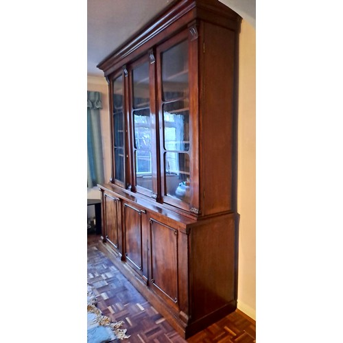 94 - A 19thC mahogany bookcase with three doors to base and three glazed doors above. 240cm h x 214cm w x... 