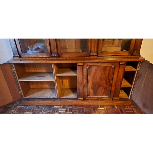 94 - A 19thC mahogany bookcase with three doors to base and three glazed doors above. 240cm h x 214cm w x... 