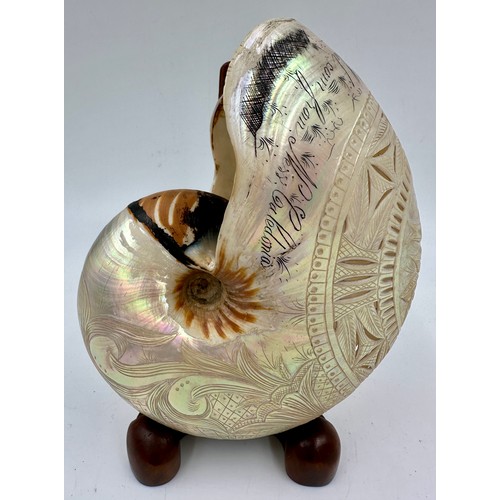 1250 - A carved and pierced 19thC nautilus shell inscribed 