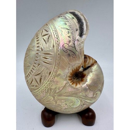 1250 - A carved and pierced 19thC nautilus shell inscribed 