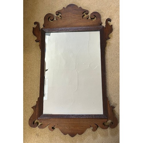 1025 - Two 19thC mahogany fretwork mirrors with the largest having a carved griffin at the top edge and she... 