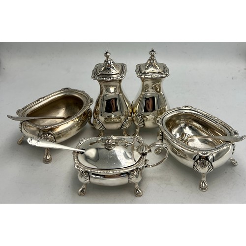 843 - Hallmarked silver cruet set comprising two salts with spoons, mustard with spoon and two peppers. To... 