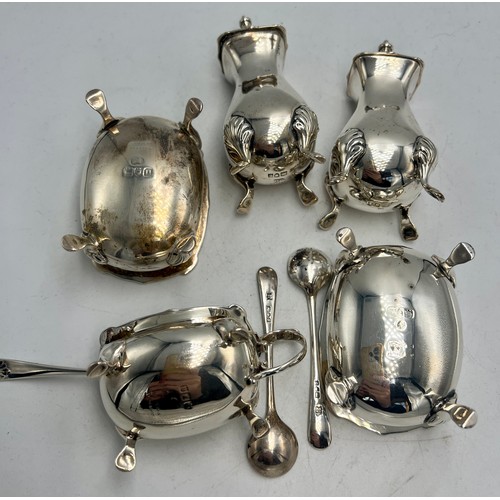 843 - Hallmarked silver cruet set comprising two salts with spoons, mustard with spoon and two peppers. To... 