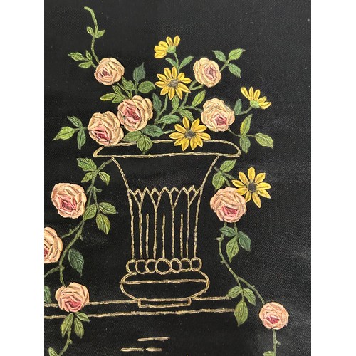 882 - A black silk panel hand stitched with a peacock and floral design, pink trim on two edges, 58cm x 58... 