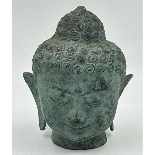 906 - Various items to include a cast bronze Buddha head, a heavy Chinese brass bowl with dragon dog mount... 