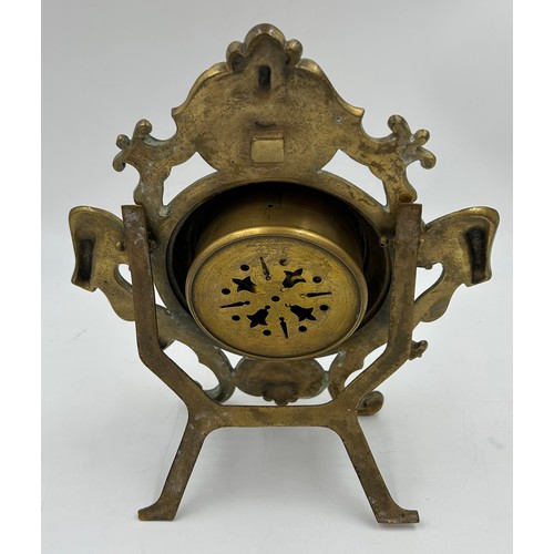 998 - A brass easel mantel clock with ceramic face 8.5cm d and roman numerals.  Movement marked SF and GB ... 