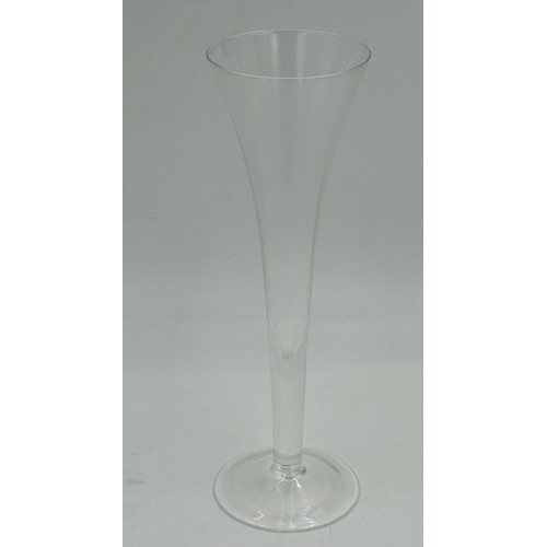 503 - A set of eight cut glass flutes with a swirl design 27.5cm h, seven fine flutes with faceted sides 2... 