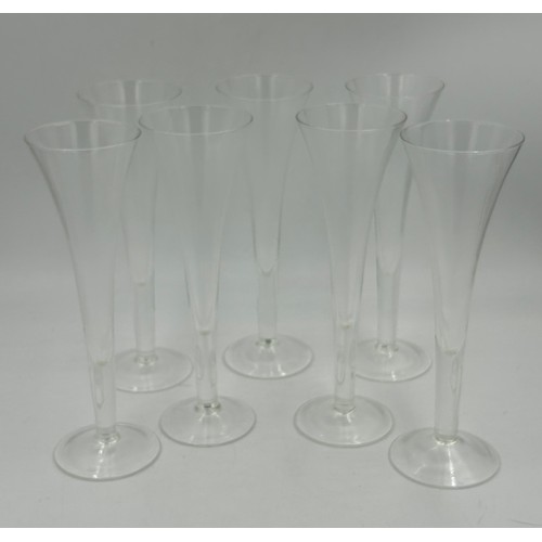 503 - A set of eight cut glass flutes with a swirl design 27.5cm h, seven fine flutes with faceted sides 2... 