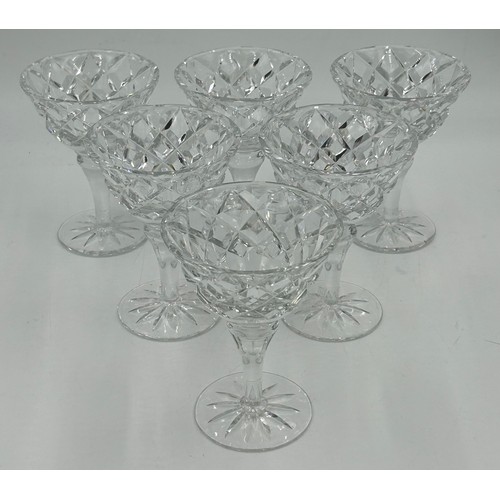 503 - A set of eight cut glass flutes with a swirl design 27.5cm h, seven fine flutes with faceted sides 2... 