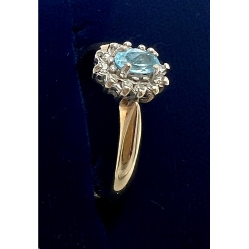 679 - A 9 carat gold gem set cluster ring with pale blue stone surrounded by clear stones. Size N. Weight ... 