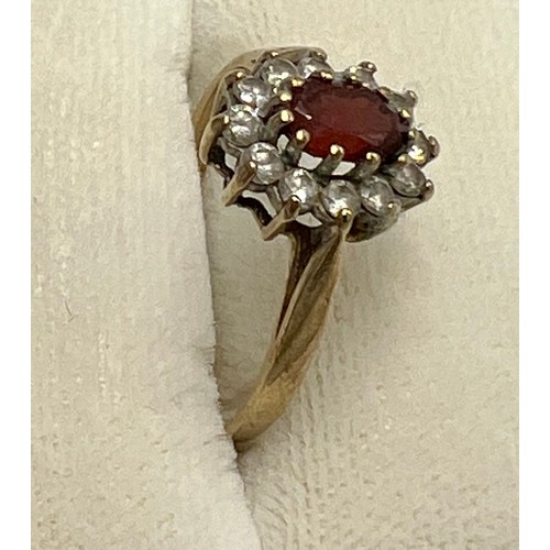 687 - A 9 carat ring set with cubic zircona and red stone. Size M. Weight 1.7gm.