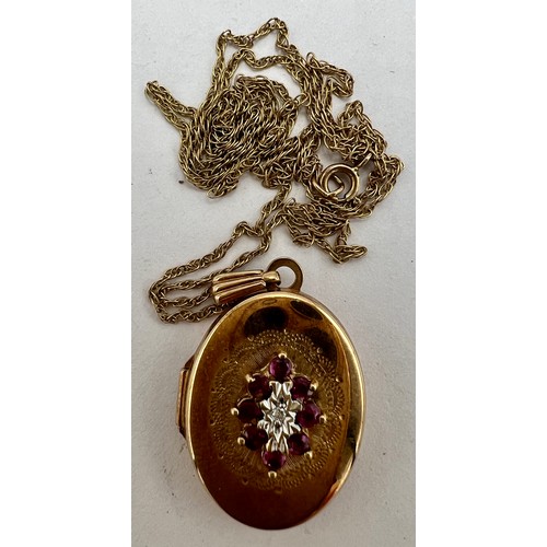 691 - A 9 carat gold oval locket set with rubies and diamonds, suspended on a nine carat gold chain. Total... 