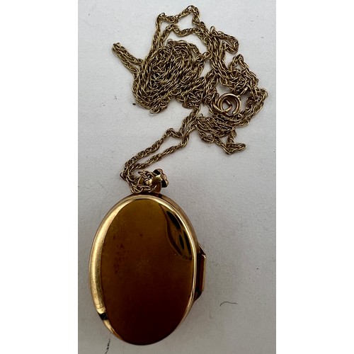 691 - A 9 carat gold oval locket set with rubies and diamonds, suspended on a nine carat gold chain. Total... 