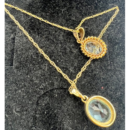 692 - Two 9 carat gold blue stone pendants. Chains 47cm l. Total weight 4.3gm.