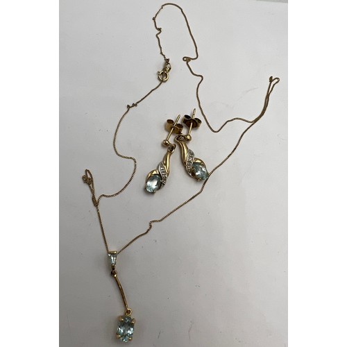 695 - Nine carat gold blue stone pendant on chain together with a pair of unmarked yellow metal earrings. ... 