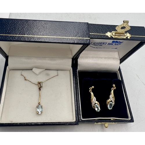 695 - Nine carat gold blue stone pendant on chain together with a pair of unmarked yellow metal earrings. ... 