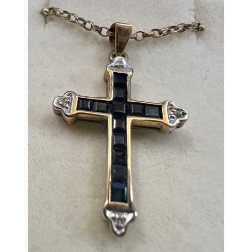 698 - A 9 carat gold gem set crucifix, 2.5cm x 2cm approximately, on a 9 carat gold chain. Total weight 3.... 