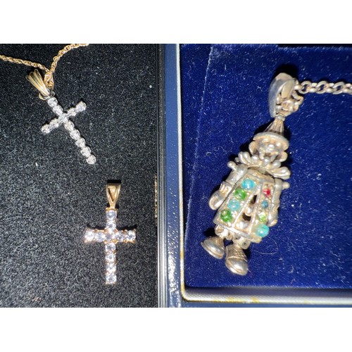 699 - Nine carat gold chain and two 9 carat gold gem set crucifix, 2.2gm, together with a silver gem set c... 