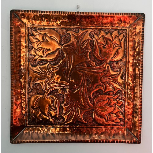 907 - An Arts and Crafts copper tray with flower design. 40 x 40cm.