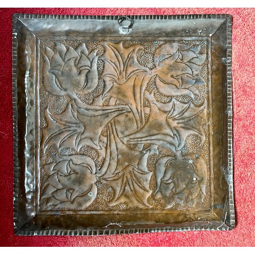 907 - An Arts and Crafts copper tray with flower design. 40 x 40cm.