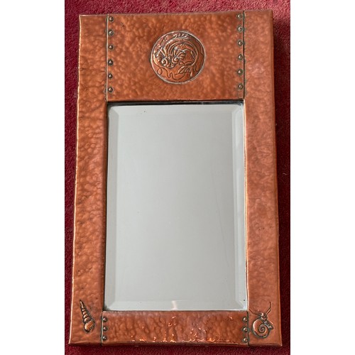 1026 - An Arts and Crafts Newlyn style hammered copper wall mirror with fish and shell design. 46 x 28cm.