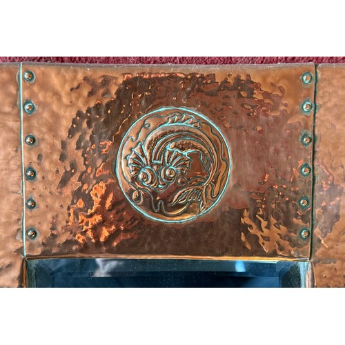 1026 - An Arts and Crafts Newlyn style hammered copper wall mirror with fish and shell design. 46 x 28cm.