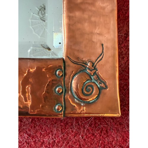 1026 - An Arts and Crafts Newlyn style hammered copper wall mirror with fish and shell design. 46 x 28cm.