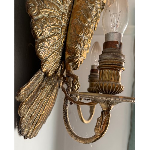 977 - A good quality brass wall mounted owl with electrified candle holders supported by snakes clutched i... 