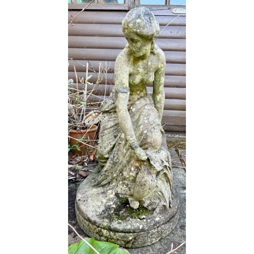 18 - A female statue in reconstituted stone. 65cm h.