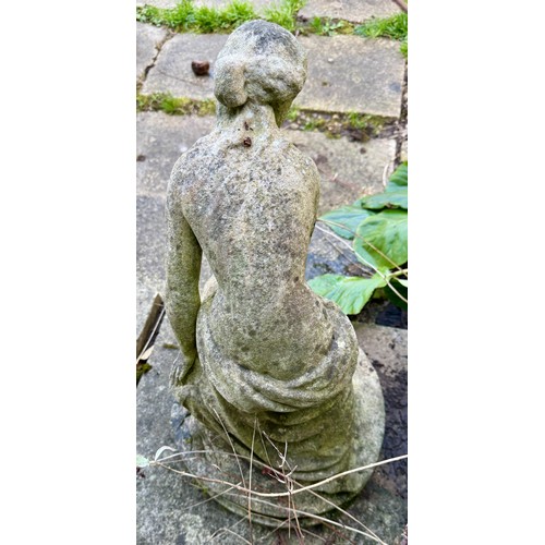 18 - A female statue in reconstituted stone. 65cm h.