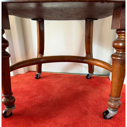 100 - A 19thC mahogany and leather upholstered armchair.