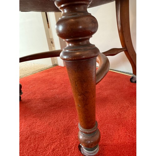 100 - A 19thC mahogany and leather upholstered armchair.