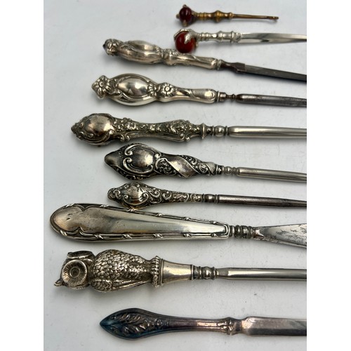 854 - Ten various silver and brass handled button hooks, shoehorn, nail file etc to include owl button hoo... 