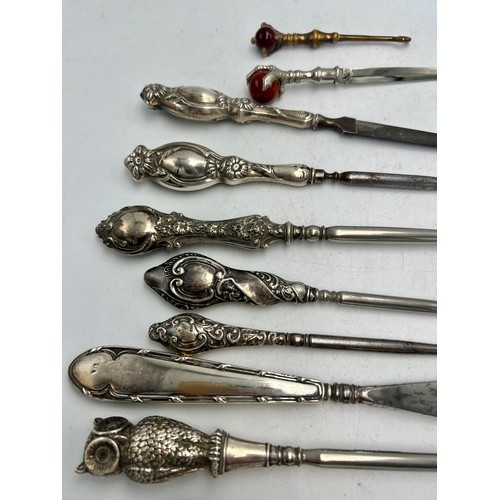 854 - Ten various silver and brass handled button hooks, shoehorn, nail file etc to include owl button hoo... 