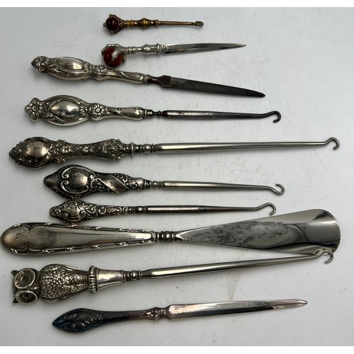 854 - Ten various silver and brass handled button hooks, shoehorn, nail file etc to include owl button hoo... 