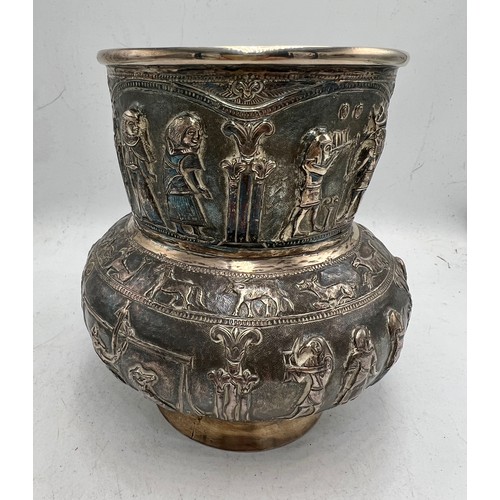 855 - Egyptian revival white metal vase with figures and animals in relief. Marked T.90 to base. 14cm h. W... 