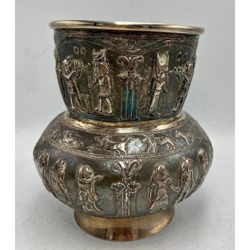 855 - Egyptian revival white metal vase with figures and animals in relief. Marked T.90 to base. 14cm h. W... 