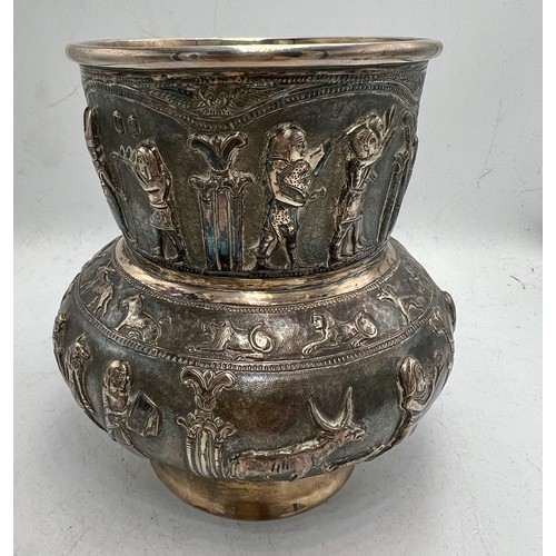 855 - Egyptian revival white metal vase with figures and animals in relief. Marked T.90 to base. 14cm h. W... 