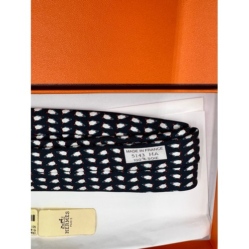 883 - An Hermès silk tie with penguin decoration in original presentation box.