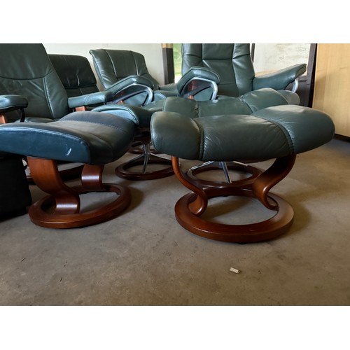 101 - Five dark green leather Stressless chairs all with footstools. One footstool opening up for storage.