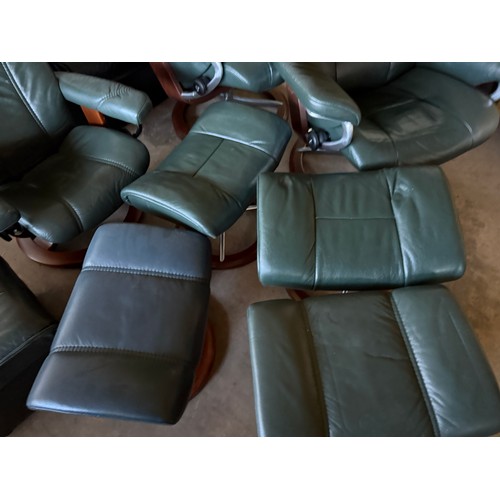 101 - Five dark green leather Stressless chairs all with footstools. One footstool opening up for storage.