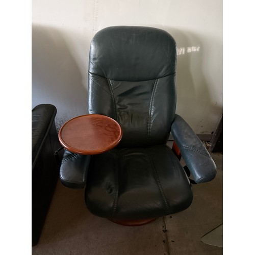 101 - Five dark green leather Stressless chairs all with footstools. One footstool opening up for storage.