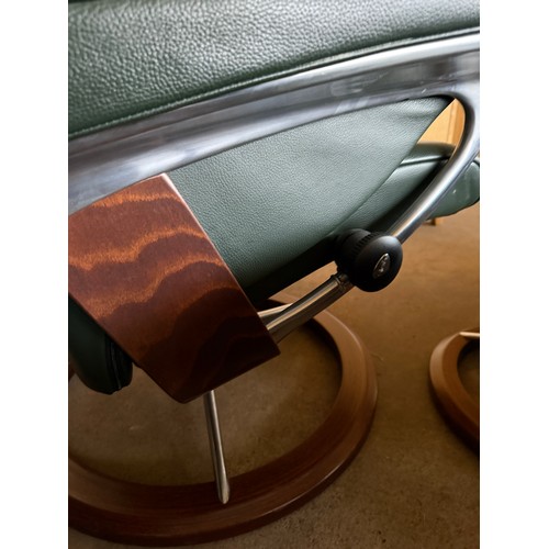 101 - Five dark green leather Stressless chairs all with footstools. One footstool opening up for storage.