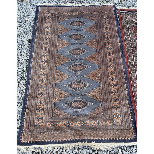 1105 - Two wool rugs. Red ground 150 x 96cm excl. tassels, blue ground 94 x 146cm excl. tassels.