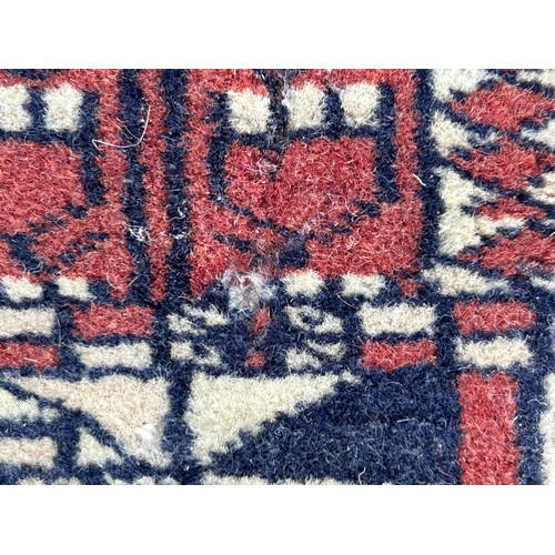 1105 - Two wool rugs. Red ground 150 x 96cm excl. tassels, blue ground 94 x 146cm excl. tassels.