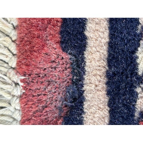 1105 - Two wool rugs. Red ground 150 x 96cm excl. tassels, blue ground 94 x 146cm excl. tassels.