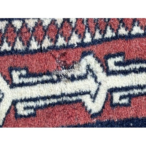 1105 - Two wool rugs. Red ground 150 x 96cm excl. tassels, blue ground 94 x 146cm excl. tassels.