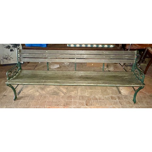 19 - A wooden garden bench with green cast iron ends. 202 w x 69cm h.