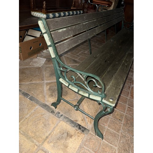 19 - A wooden garden bench with green cast iron ends. 202 w x 69cm h.