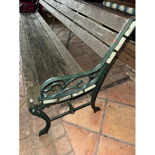 19 - A wooden garden bench with green cast iron ends. 202 w x 69cm h.